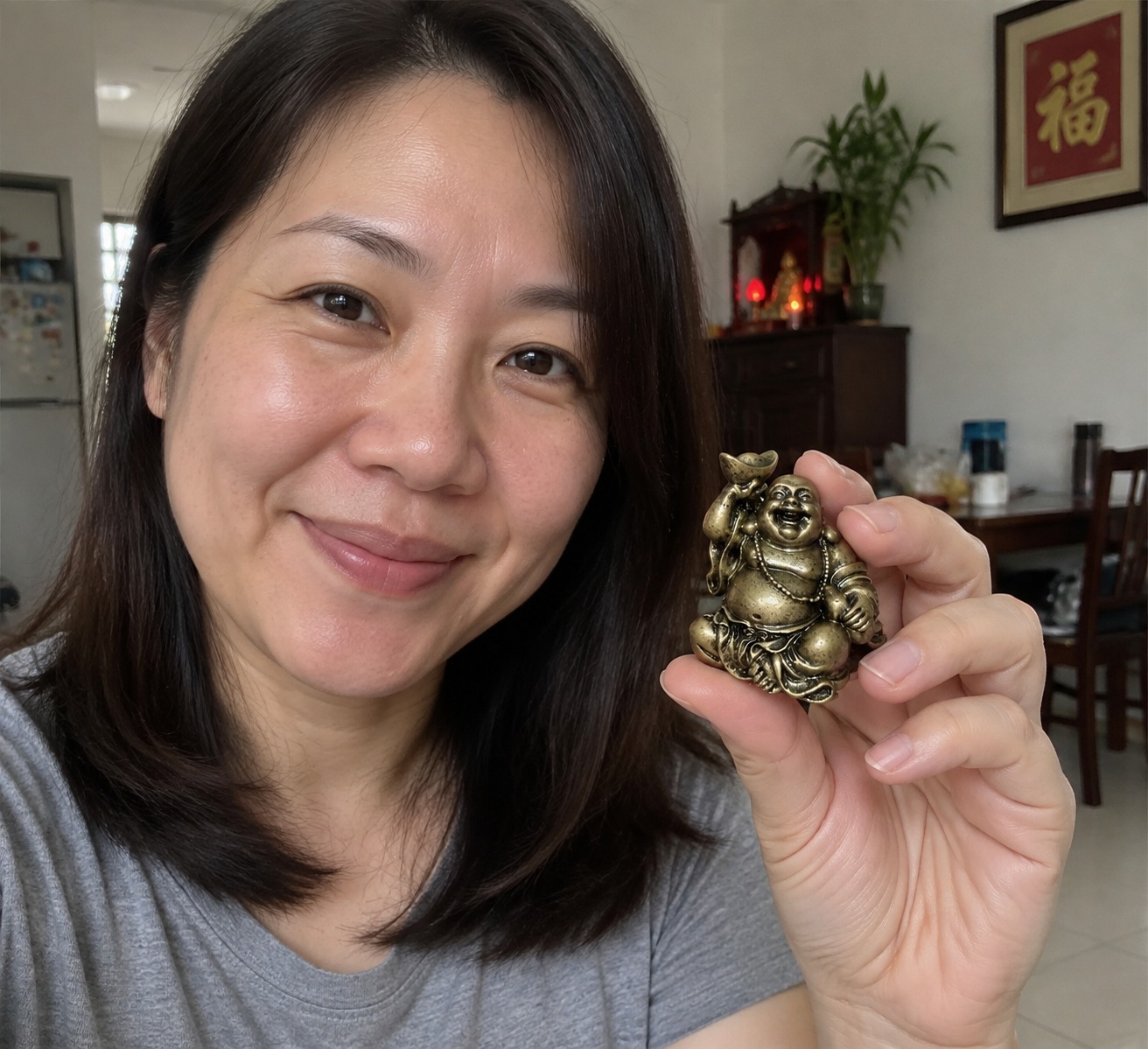 Mini Laughing Buddha 笑佛 bronze-colour resin statue in a home
